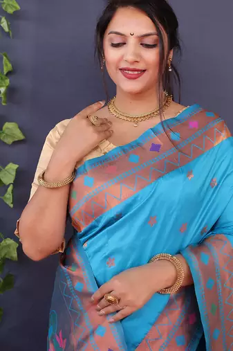 Aqua blue banarasi silk blend saree with copper zari butti & geometric woven border