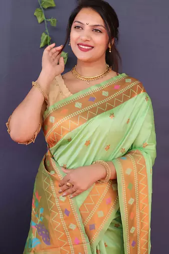 Mint green banarasi silk blend saree with copper zari butti & geometric woven border