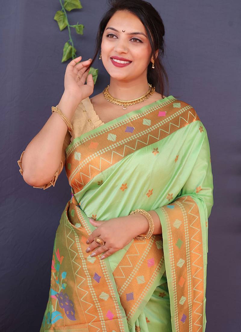 Mint green banarasi silk blend saree with copper zari butti & geometric woven border