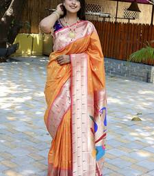 Orange silk blend paithani saree with peacock pallu, golden zari border
