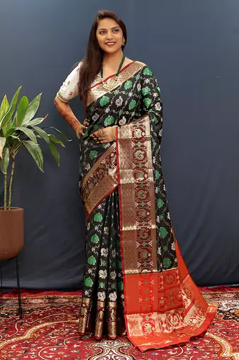 Black silk blend patola saree with zari border and contrast red pallu