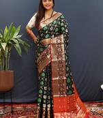 Black silk blend patola saree with zari border and contrast red pallu