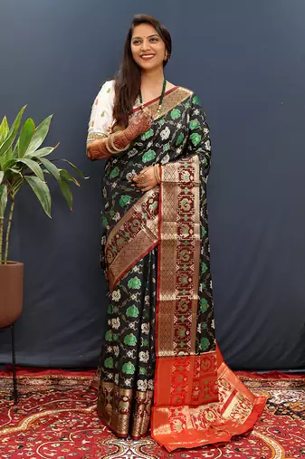 Black silk blend patola saree with zari border and contrast red pallu