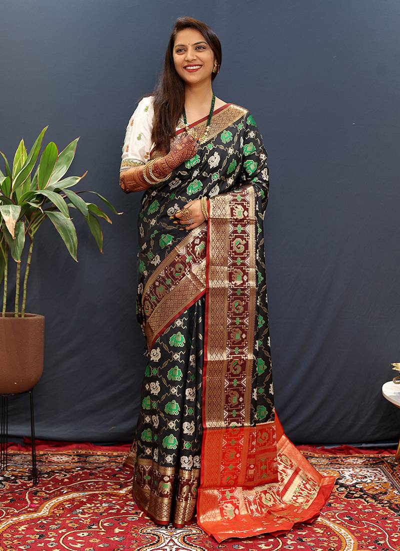 Black silk blend patola saree with zari border and contrast red pallu