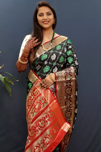 Black silk blend patola saree with zari border and contrast red pallu