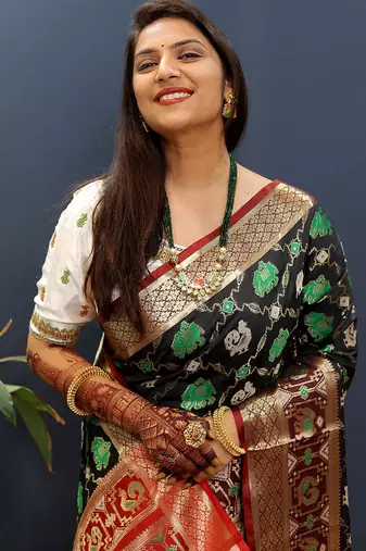 Black silk blend patola saree with zari border and contrast red pallu