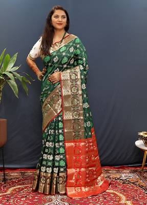 Dark green silk blend patola saree with zari border and contrast red pallu 1