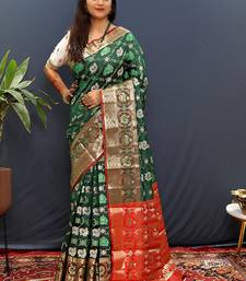 Dark green silk blend patola saree with zari border and contrast red pallu