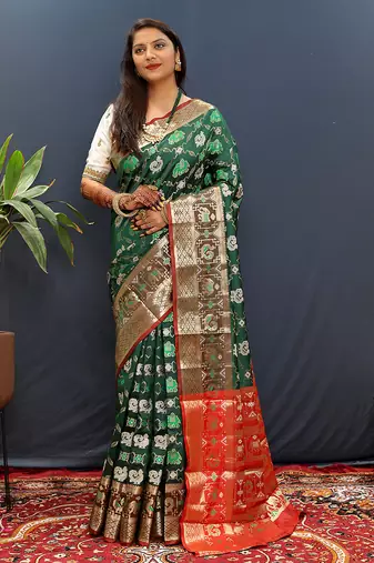 Dark green silk blend patola saree with zari border and contrast red pallu