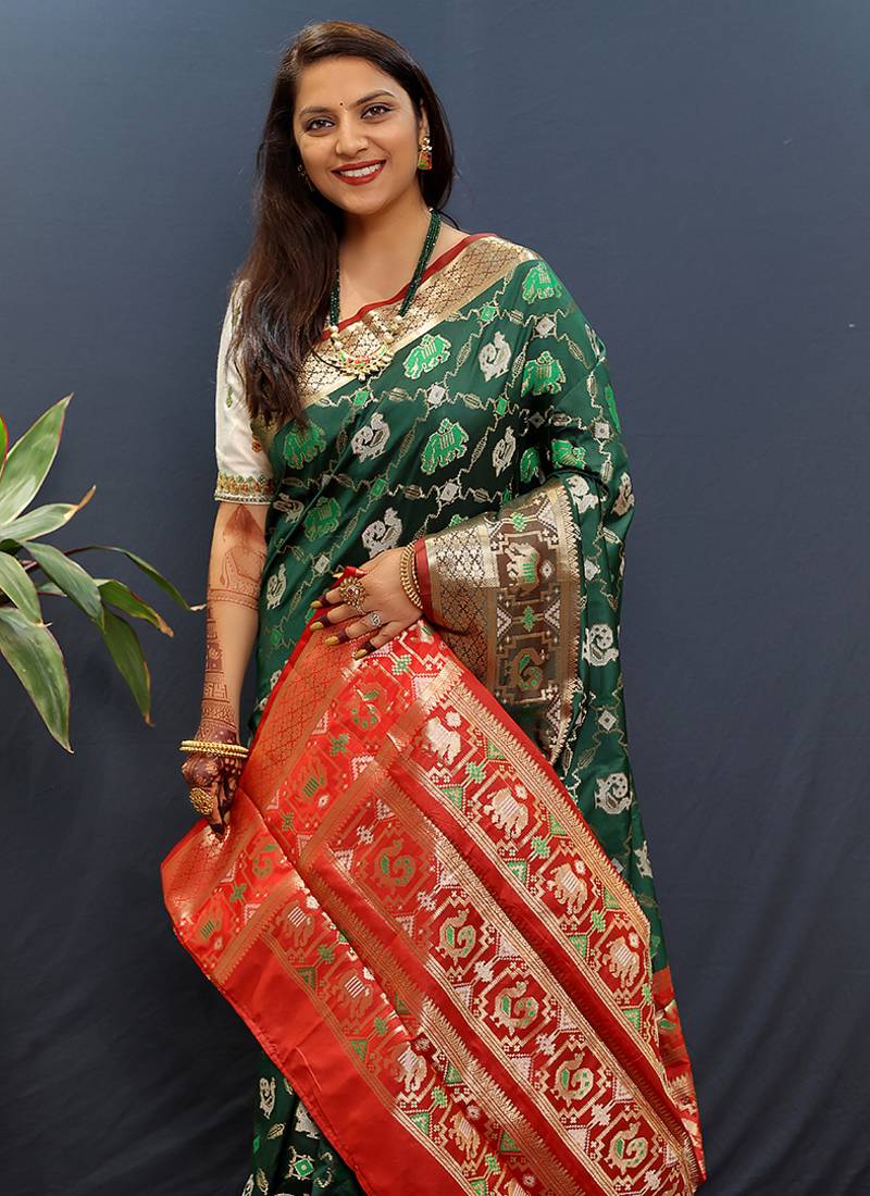 Dark green silk blend patola saree with zari border and contrast red pallu