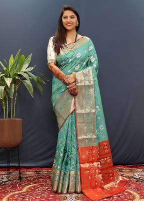 Turquoise silk blend patola saree with zari border and contrast red pallu 1
