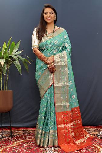 Turquoise silk blend patola saree with zari border and contrast red pallu