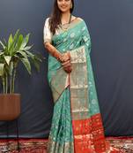 Turquoise silk blend patola saree with zari border and contrast red pallu