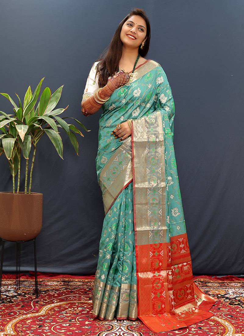 Turquoise silk blend patola saree with zari border and contrast red pallu