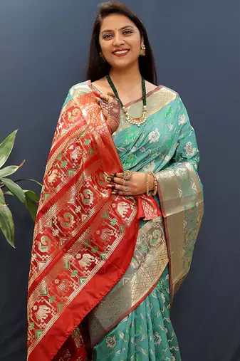Turquoise silk blend patola saree with zari border and contrast red pallu