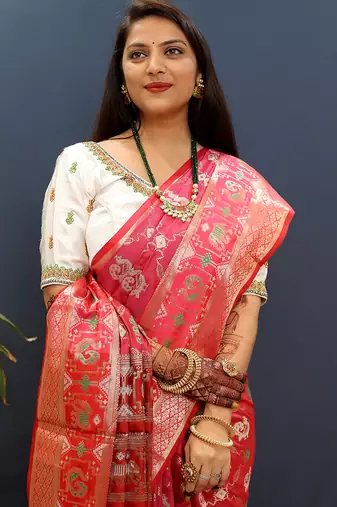 Rani pink silk blend patola saree with zari border and contrast red pallu