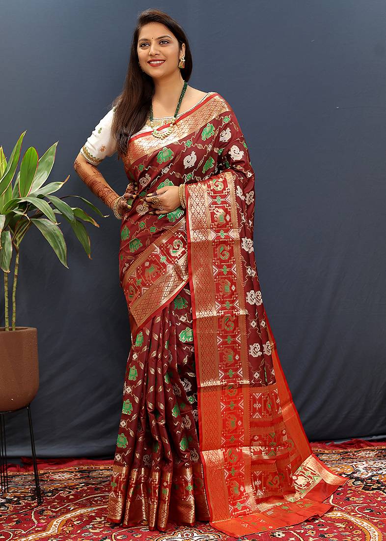 Maroon silk blend patola saree with zari border and contrast red pallu
