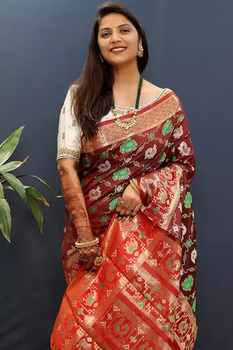 Maroon silk blend patola saree with zari border and contrast red pallu