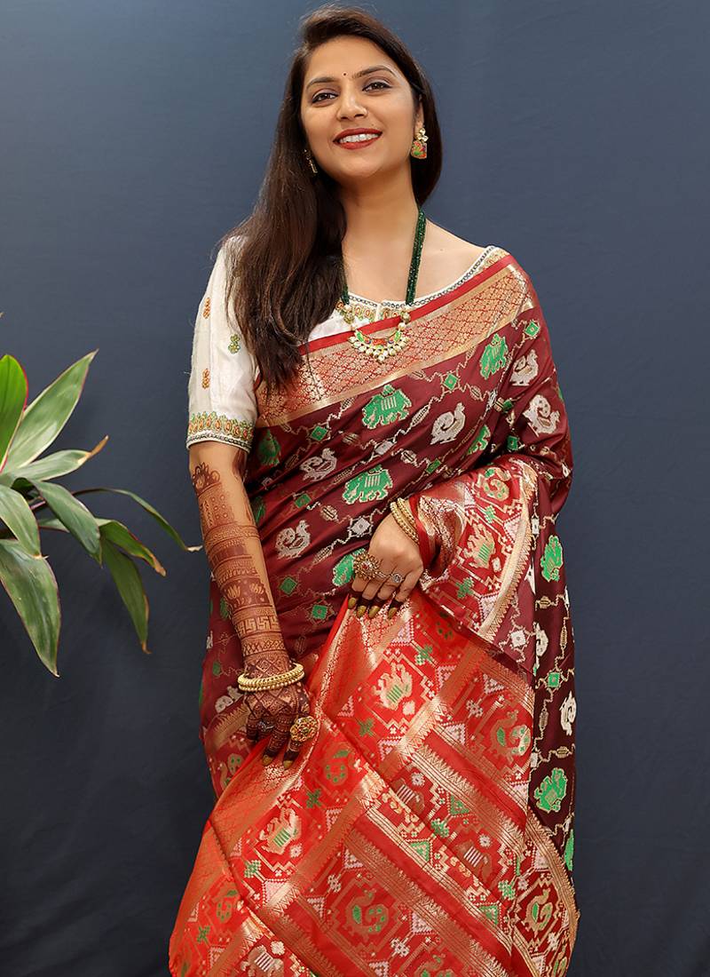 Maroon silk blend patola saree with zari border and contrast red pallu