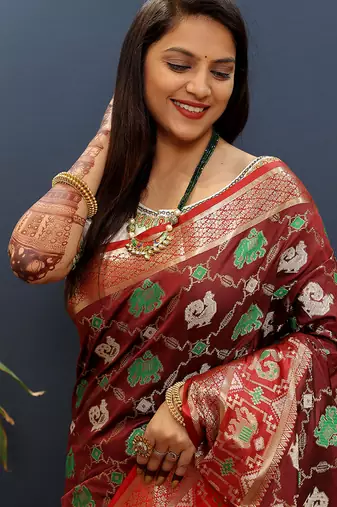 Maroon silk blend patola saree with zari border and contrast red pallu