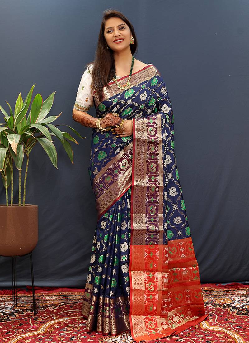 Navy blue silk blend patola saree with zari border and contrast red pallu