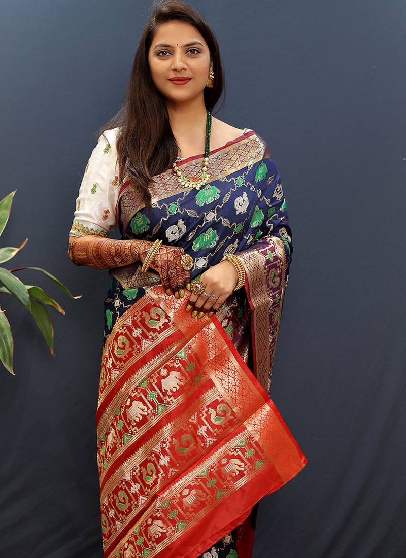 Navy blue silk blend patola saree with zari border and contrast red pallu
