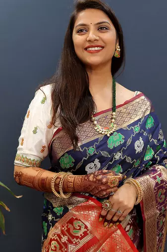 Navy blue silk blend patola saree with zari border and contrast red pallu