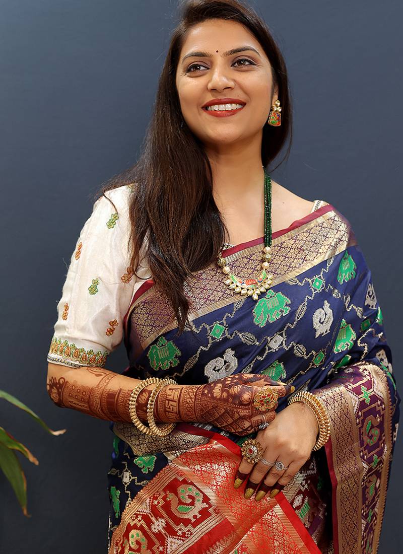 Navy blue silk blend patola saree with zari border and contrast red pallu