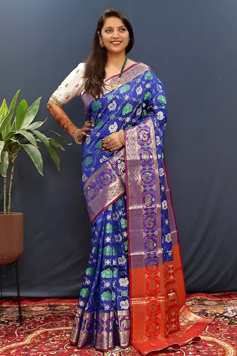 Royal blue silk blend patola saree with zari border and contrast red pallu