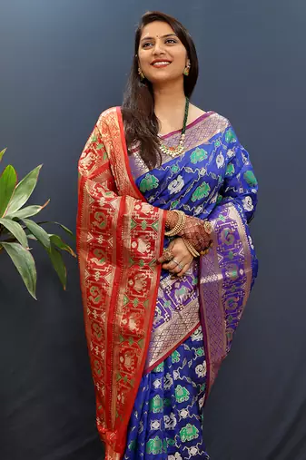 Royal blue silk blend patola saree with zari border and contrast red pallu