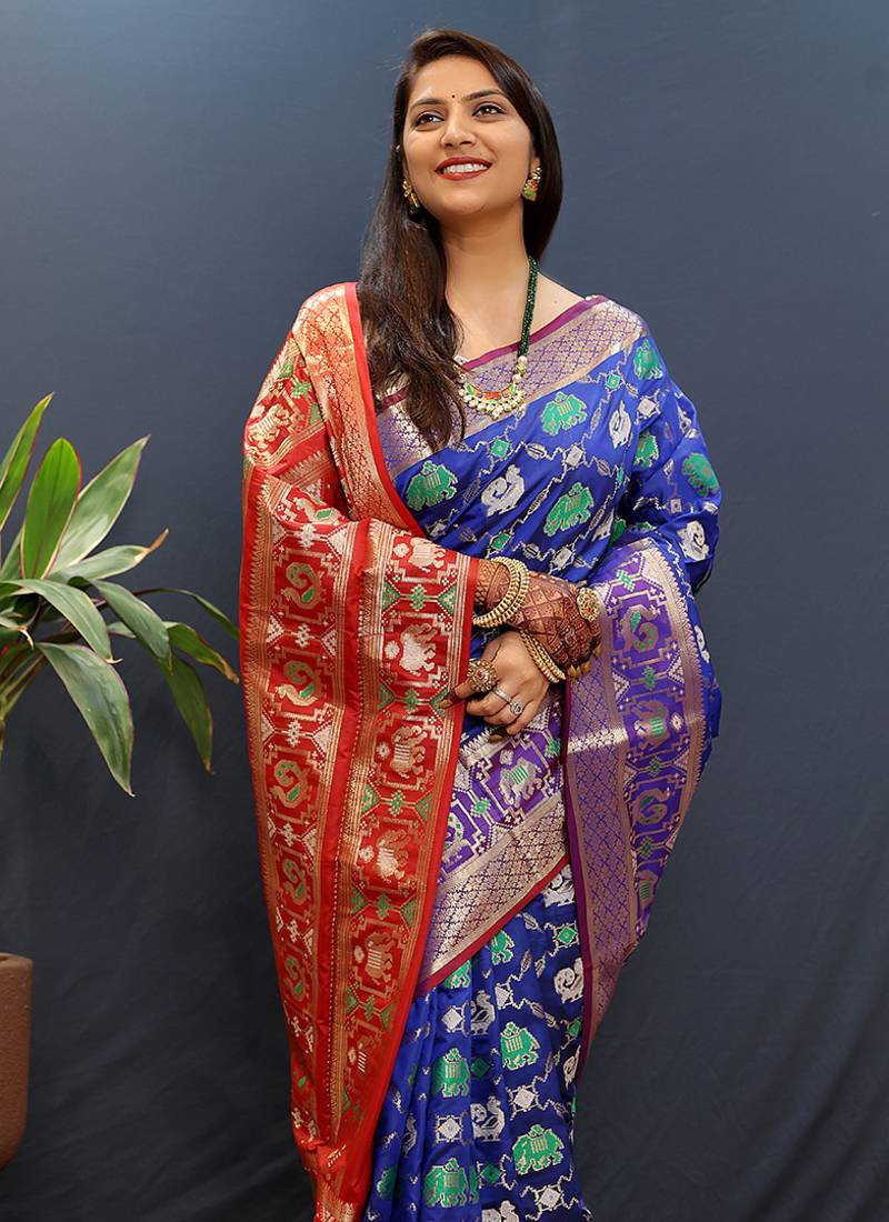 Royal blue silk blend patola saree with zari border and contrast red pallu