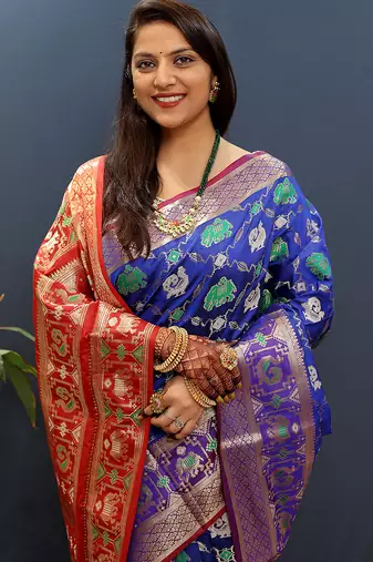 Royal blue silk blend patola saree with zari border and contrast red pallu