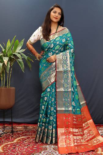 Teal blue silk blend patola saree with zari border and contrast red pallu