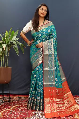 Teal blue silk blend patola saree with zari border and contrast red pallu