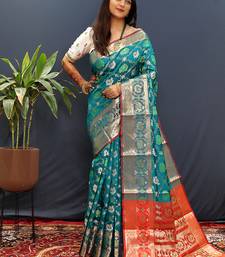 Teal blue silk blend patola saree with zari border and contrast red pallu