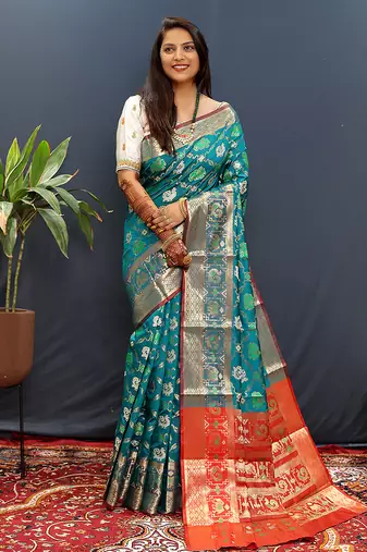 Teal blue silk blend patola saree with zari border and contrast red pallu