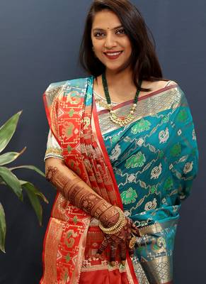 Teal blue silk blend patola saree with zari border and contrast red pallu 4