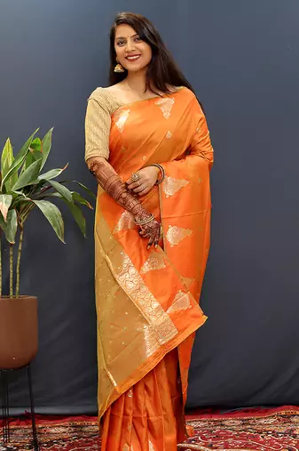 Orange silk blend banarasi saree with golden zari buti and border