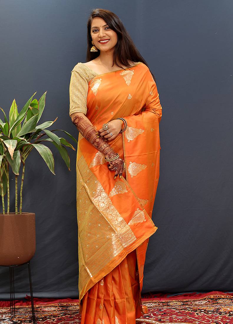 Orange silk blend banarasi saree with golden zari buti and border