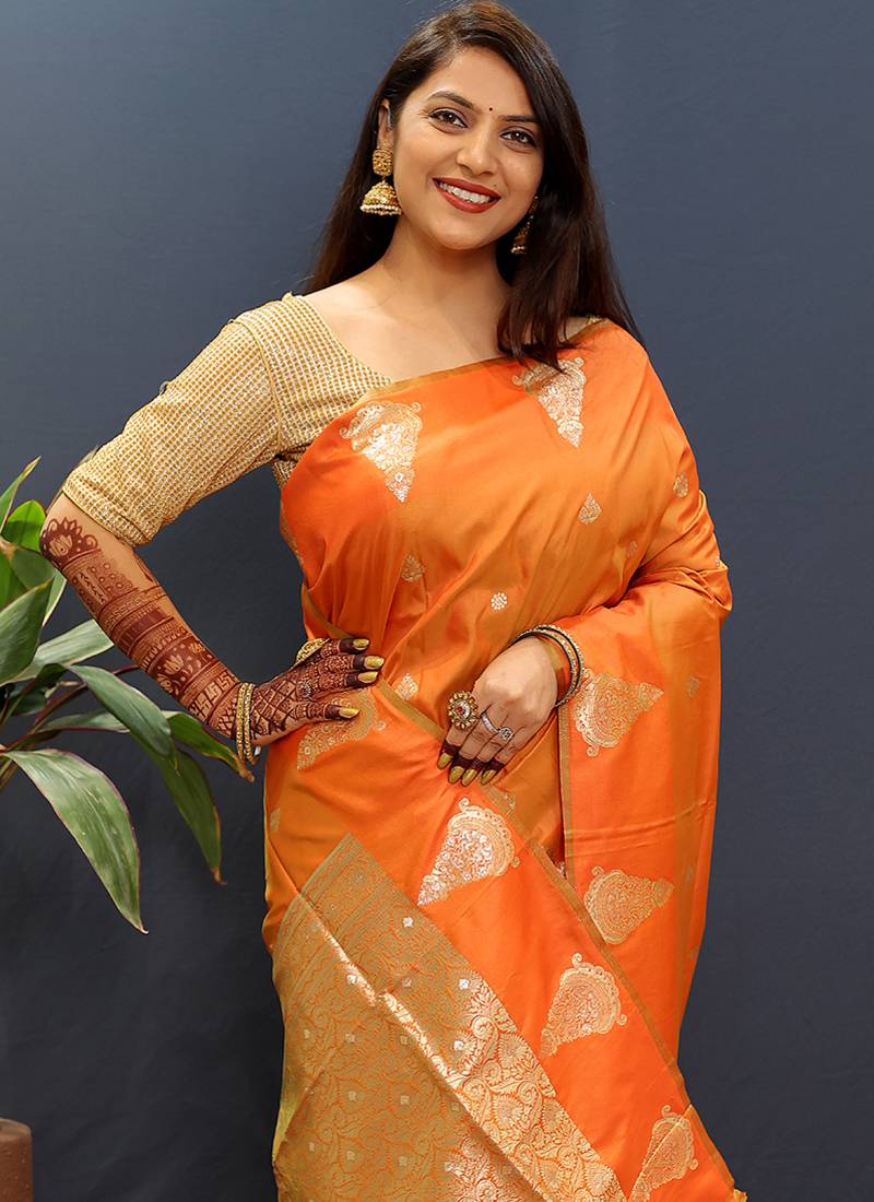 Orange silk blend banarasi saree with golden zari buti and border