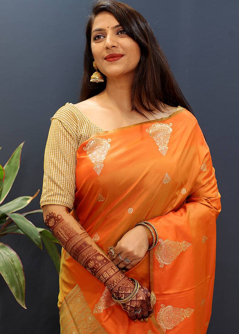 Orange silk blend banarasi saree with golden zari buti and border