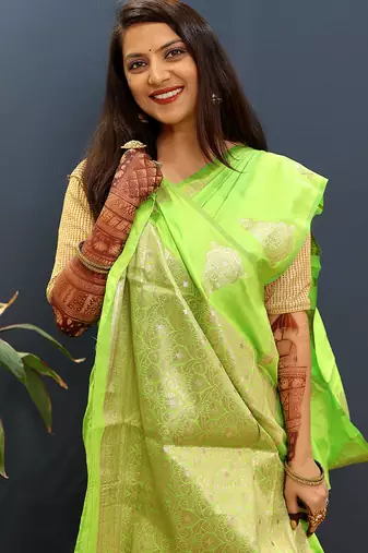 Lime green silk blend banarasi saree with golden zari buti and border