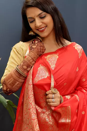 Red silk blend banarasi saree with golden zari buti and border