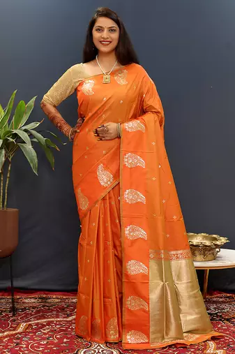 Orange silk blend banarasi saree with golden zari buti and border