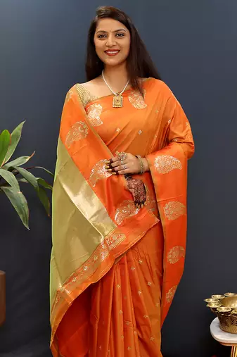 Orange silk blend banarasi saree with golden zari buti and border