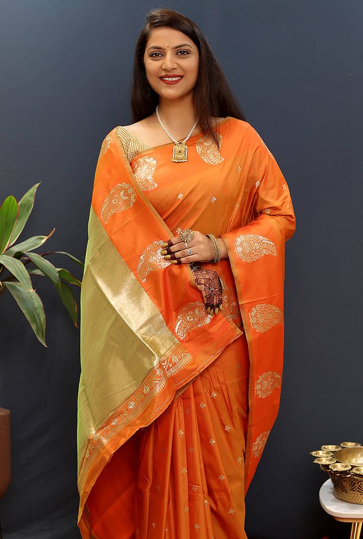 Orange silk blend banarasi saree with golden zari buti and border