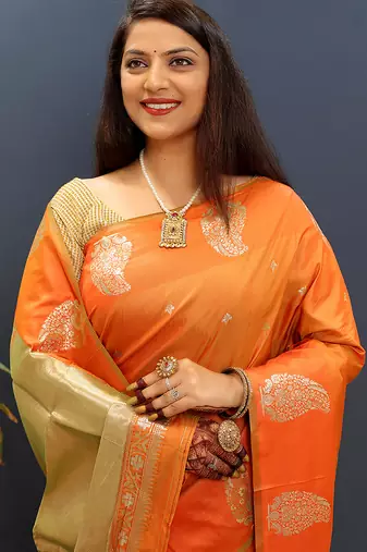 Orange silk blend banarasi saree with golden zari buti and border