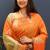 Orange silk blend banarasi saree with golden zari buti and border