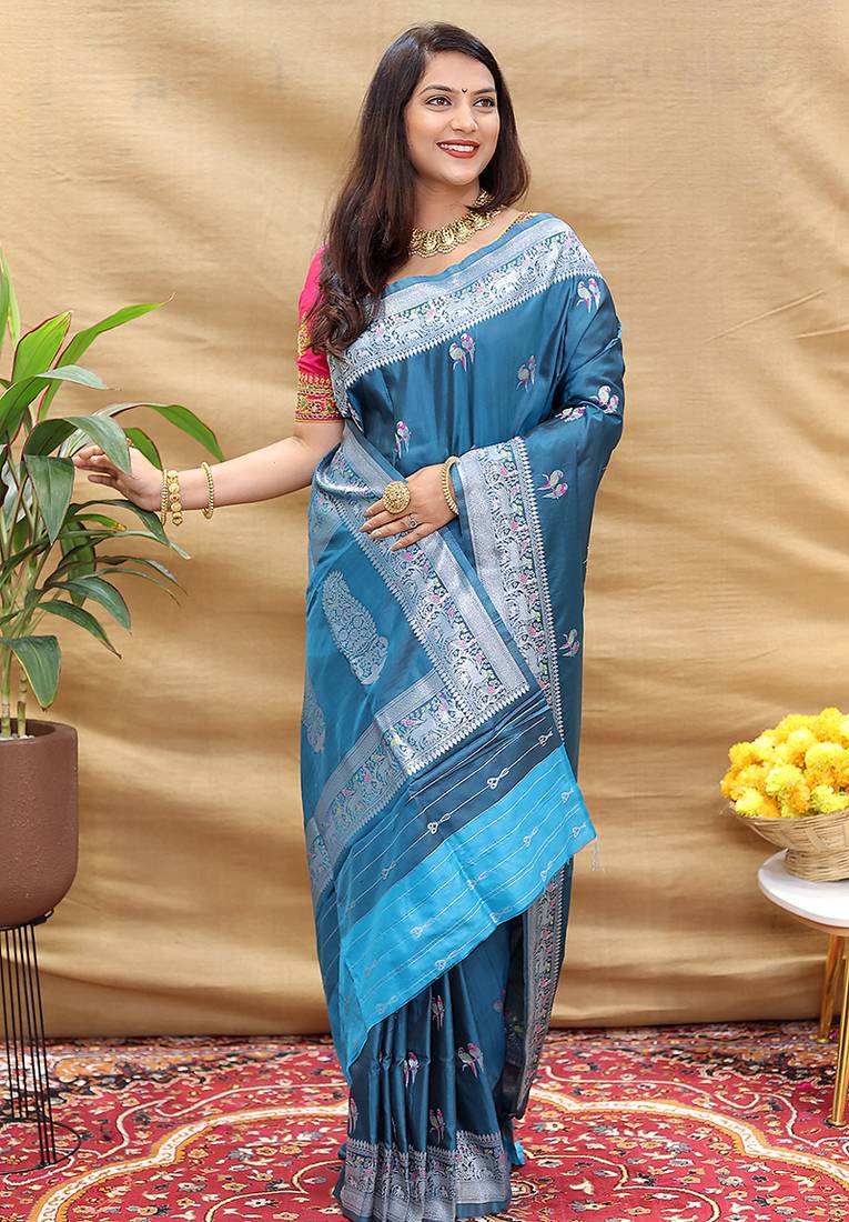 Teal blue silk blend banarasi saree with silver zari border and peacock pallu