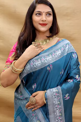 Teal blue silk blend banarasi saree with silver zari border and peacock pallu
